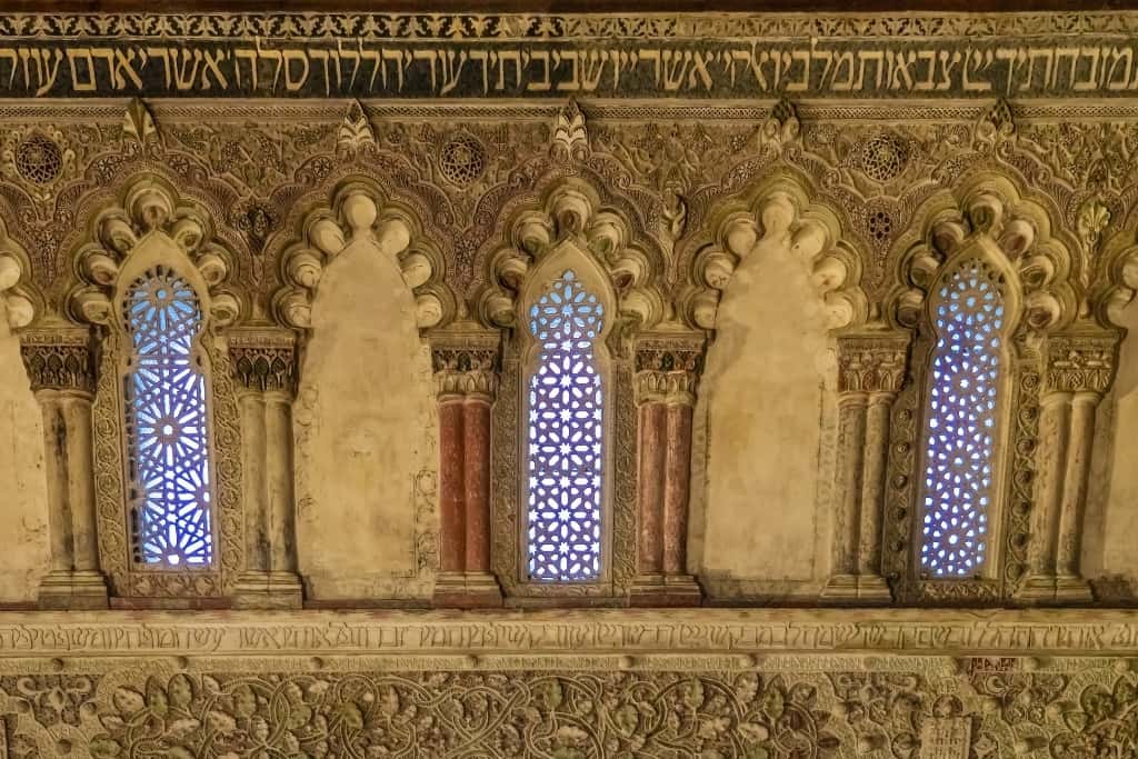 La Sinagoga del Tránsito in Toledo, Spain features windows with scallop shaped arches.